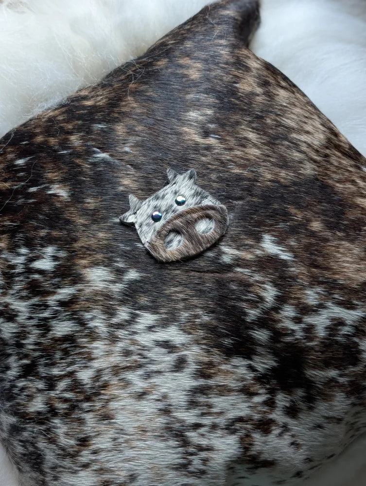 A small silver cow brooch with black bead eyes and textured snout perfect for sewing machines and angus oliver fans