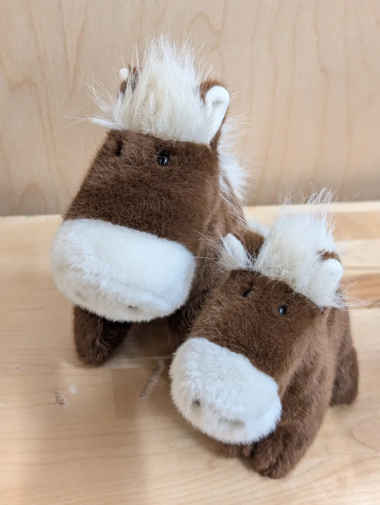 Two plush brown ponies with white manes and snouts featuring soft fur textures from the pony collection