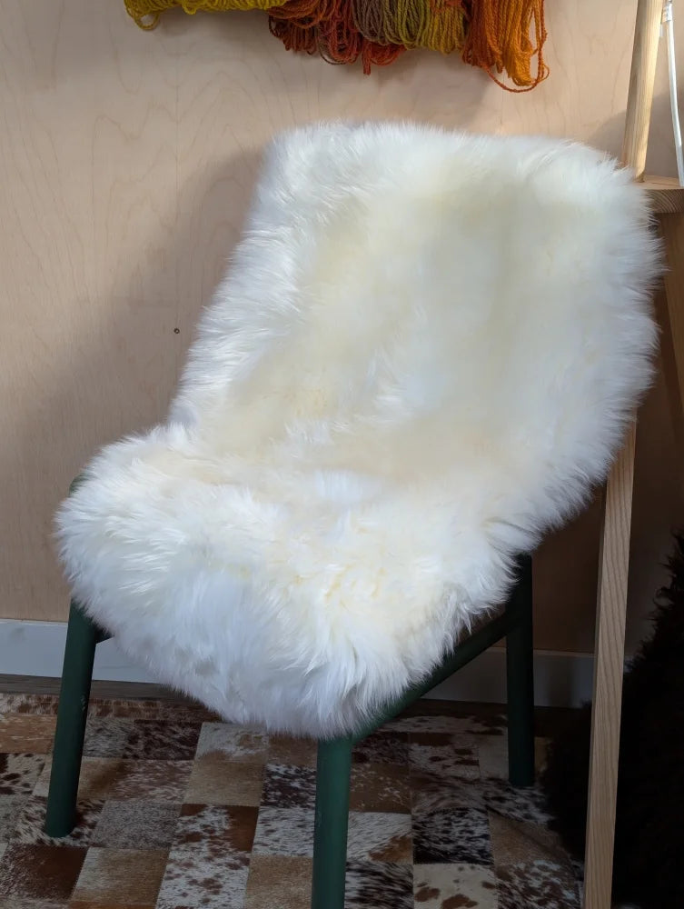 Gorgeous Merino sheepskin chair cover on green frame, OEKO TEX certified