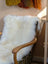 White fluffy Merino sheepskin throw on chair arm, OEKO TEX certified