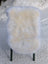 Gorgeous Merino sheepskin rug on green legs, OEKO-TEX certified, snowy backdrop