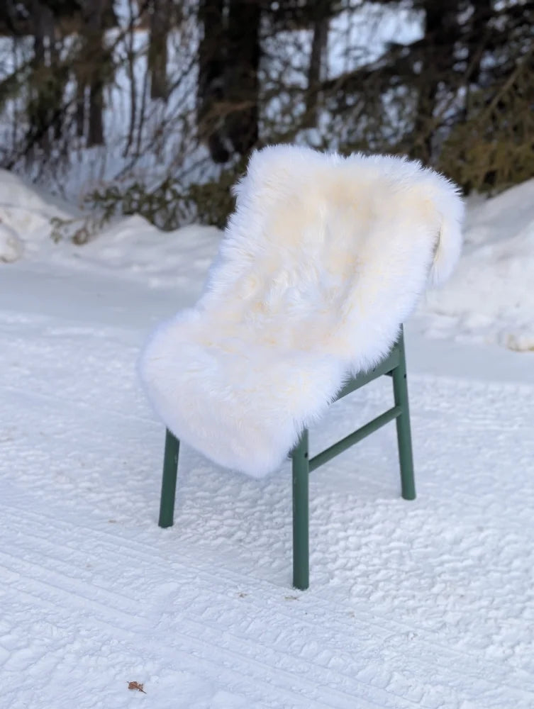 Gorgeous Merino sheepskin throw on green chair in snow, OEKO TEX certified
