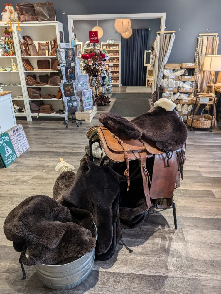 Brown merino sheepskin western saddle cover with leather saddle, silver accents, floral design