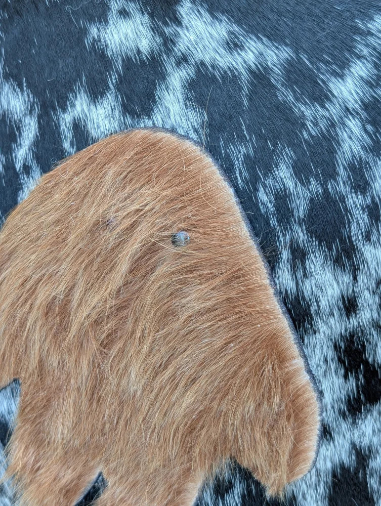 The yeti cushion cowhide patch features brown long wool icelandic sheepskin with a small dark spot perfect for sewing machines