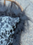 Black faux fur pillow with gray and black leopard print fabric in the yeti cushion featuring icelandic sheepskin long wool