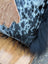 The yeti cushion cowhide pillow features black and white spots with a brown fur patch and black icelandic sheepskin trim