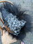 The yeti cushion cowhide pillow features black and white spots with fluffy black icelandic sheepskin trim