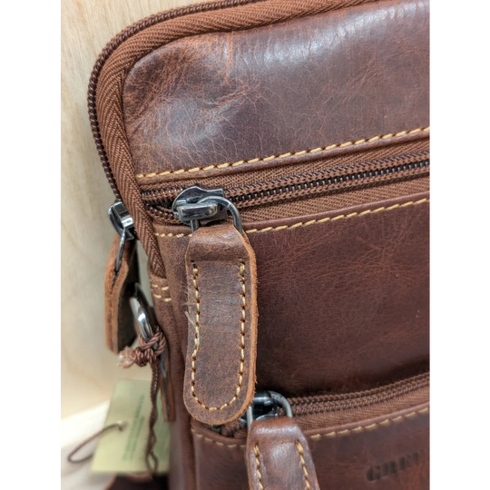 Timber mini crossbody leather bag in brown with stitching and metal zippers
