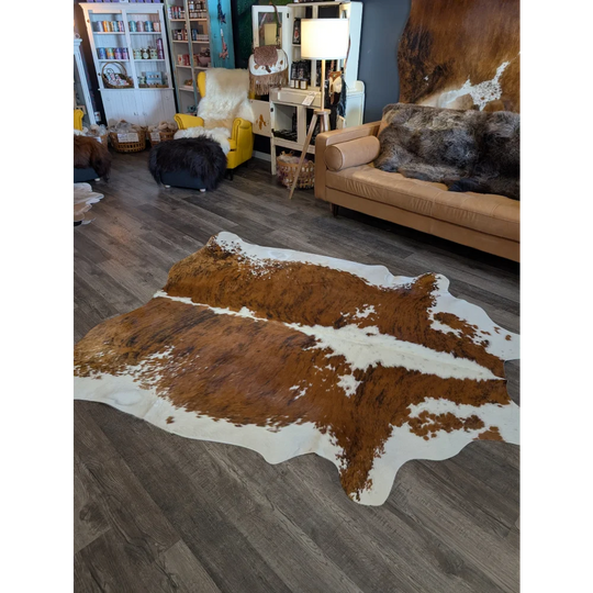 Extra large brown and white cowhide rug with natural irregular edges perfect for beautiful rugs and large cowhide decor