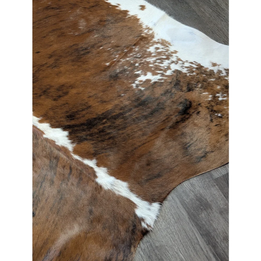 Brown and white extra large cowhide rug with natural fur texture perfect for beautiful rugs and large cowhide decor