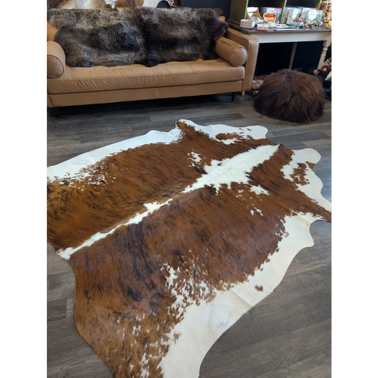 Extra large brown and white cowhide rug with natural irregular patterns perfect for beautiful rugs and large cowhide decor