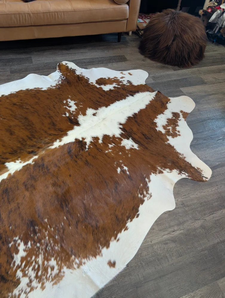 Brown and white extra large cowhide rug with natural irregular edges perfect for beautiful rugs decor