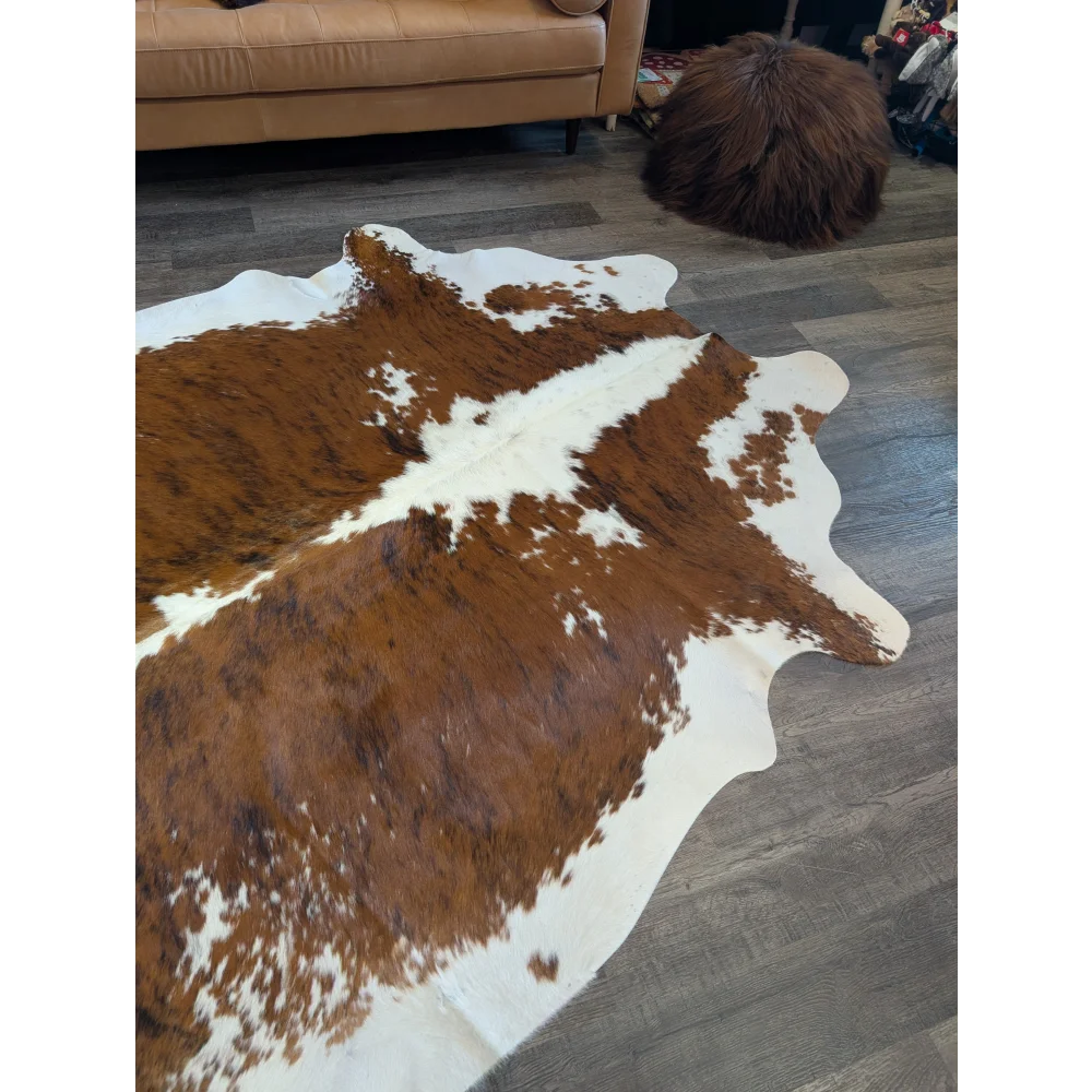 Brown and white extra large cowhide rug with natural irregular edges perfect for beautiful rugs decor