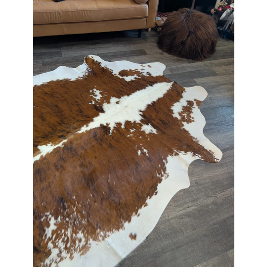 Brown and white extra large cowhide rug with natural irregular edges perfect for beautiful rugs decor