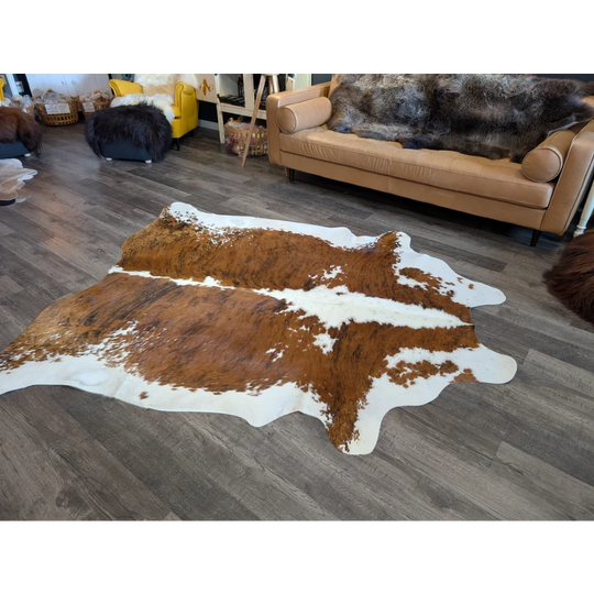 Brown and white extra large cowhide rug with natural irregular edges perfect for beautiful rugs collection