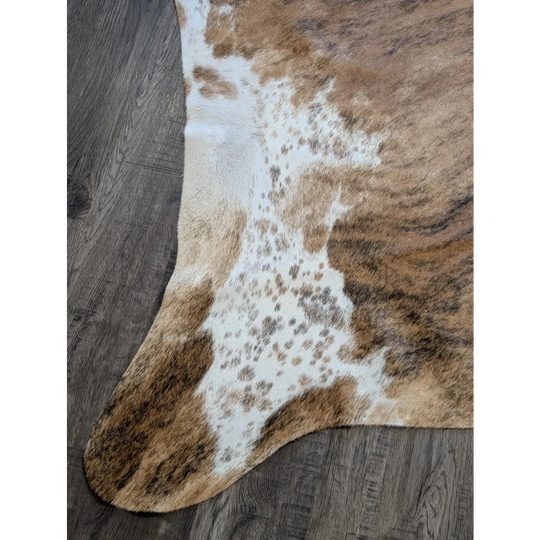 Brown and white extra large cowhide rug with natural fur texture perfect for beautiful rugs and large cowhide decor