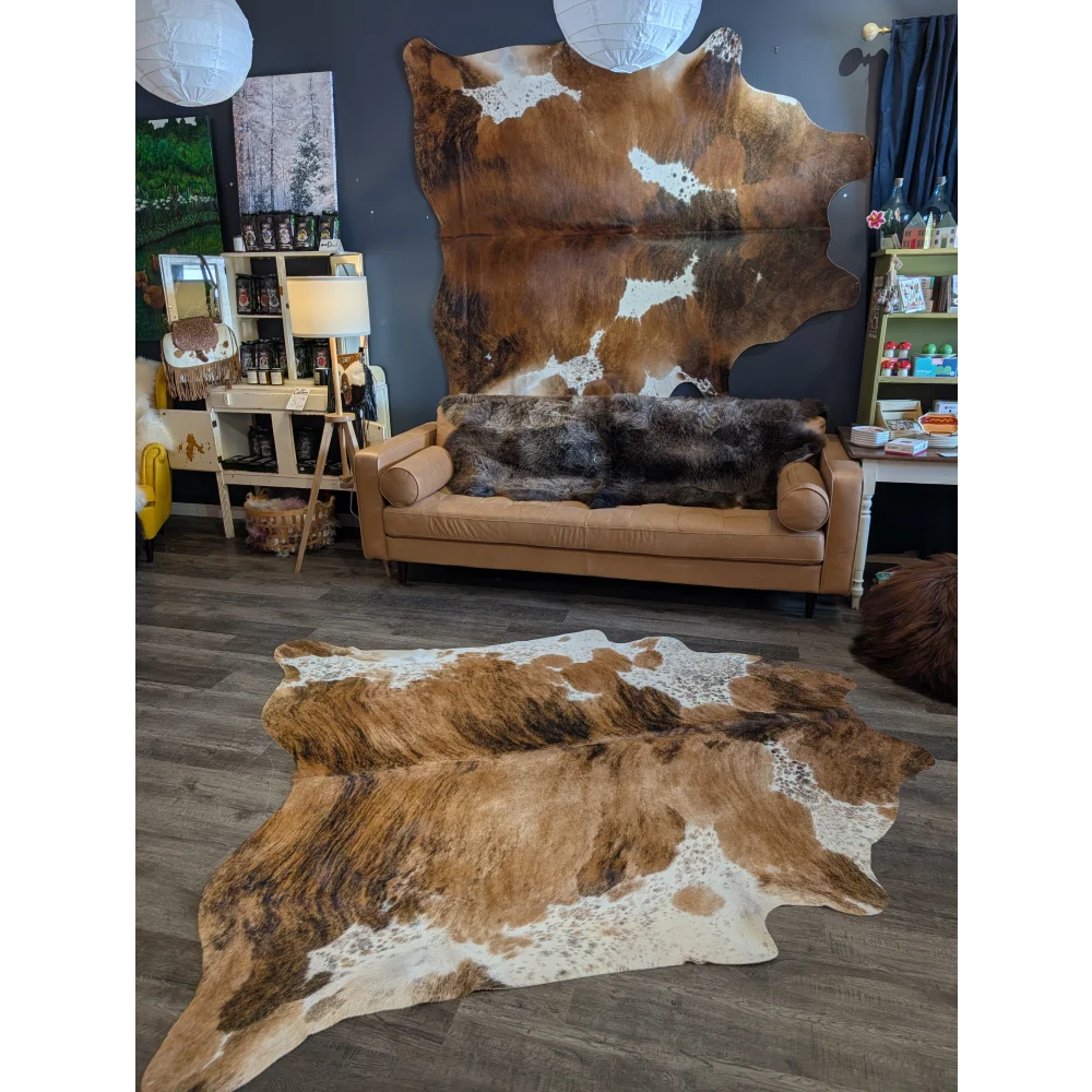 Extra large brown and white cowhide rug with natural irregular patterns perfect for beautiful rugs and large cowhide fans