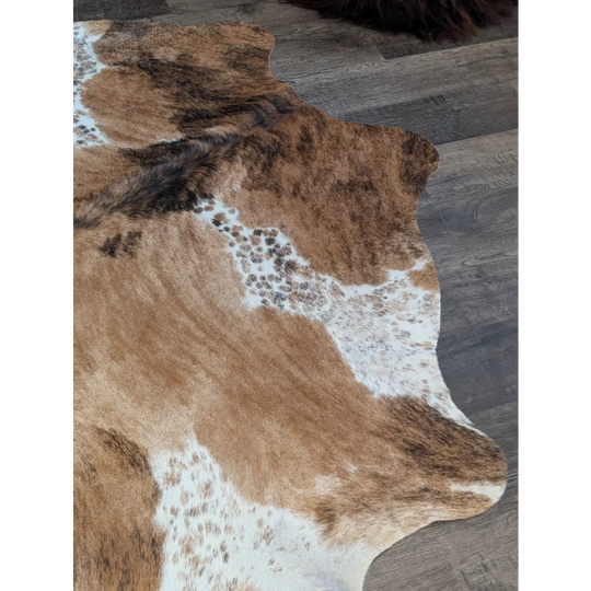 Extra large cowhide rug in brown and white with natural fur texture perfect for beautiful rugs collection