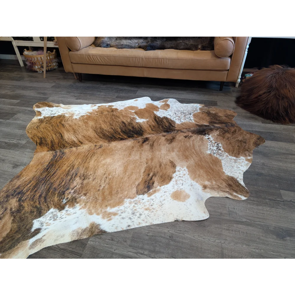 Extra large cowhide rug in brown and white with natural irregular patterns perfect for beautiful rugs and large cowhide lovers