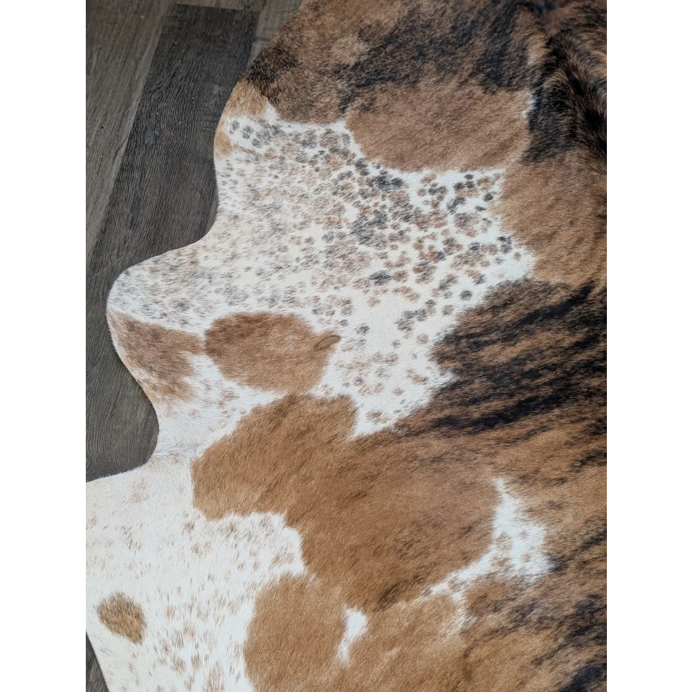 Extra large brown and white spotted cowhide rug with natural irregular edge perfect for beautiful rugs and large cowhide decor