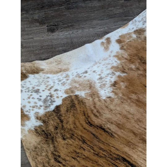 Beautiful extra large cowhide rug in brown and white with natural spotted pattern perfect for large cowhide decor