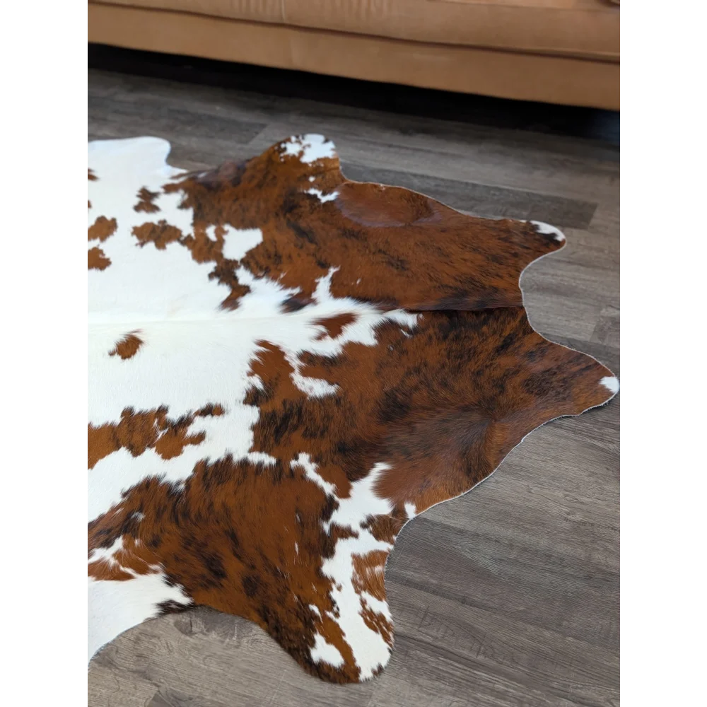 Brown and white extra large cowhide rug with natural irregular patterns perfect for beautiful rugs and large cowhide decor