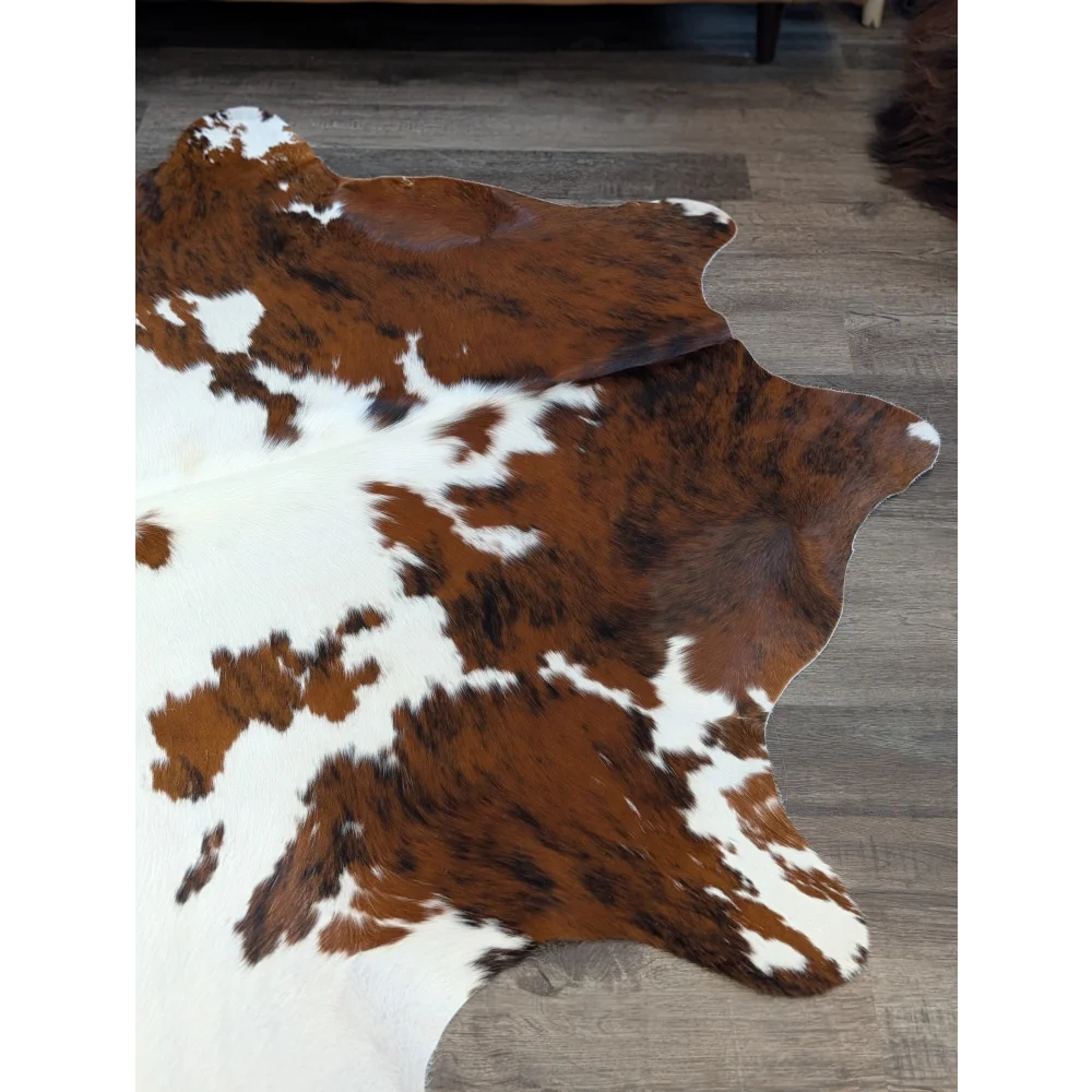 Brown and white extra large cowhide rug with natural irregular edges perfect for beautiful rugs and large cowhide decor