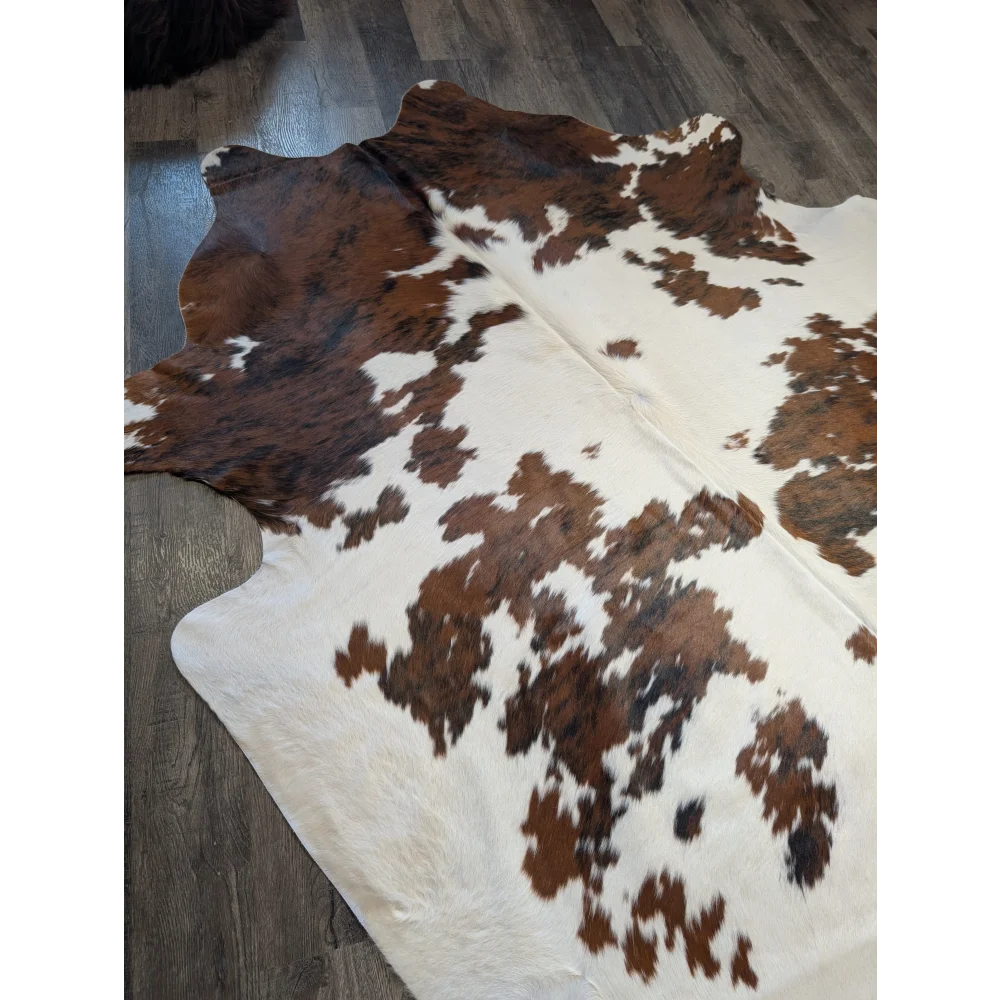 Brown and white extra large cowhide rug with natural fur texture perfect for beautiful rugs and large cowhide decor