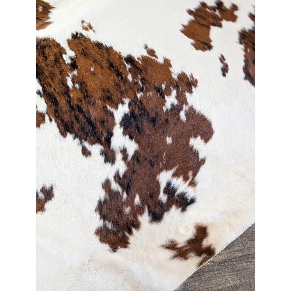 Brown and white extra large cowhide rug with natural fur texture perfect for beautiful rugs and large cowhide decor