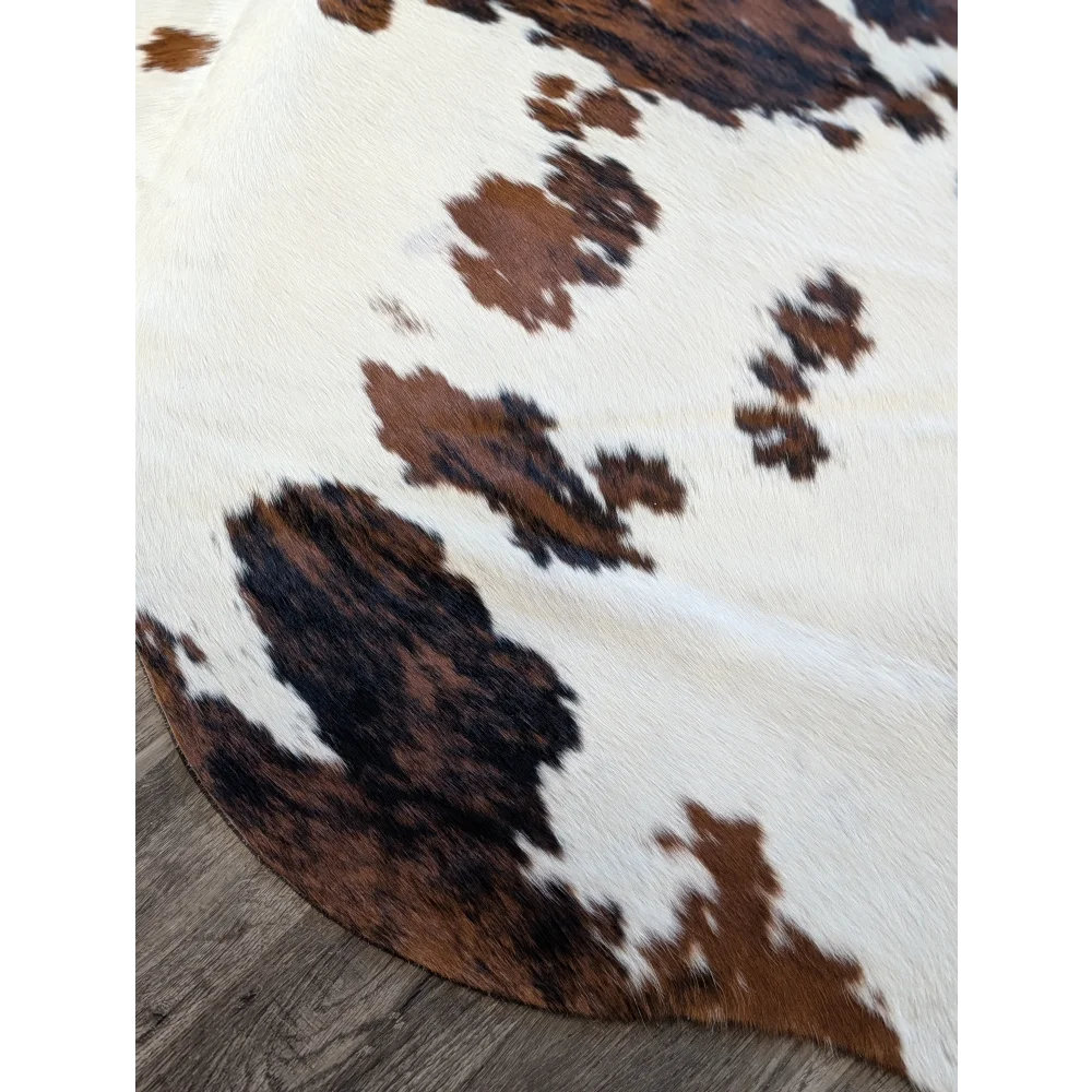 Brown and white extra large cowhide rug with natural dark brown and black patches perfect for beautiful rugs lovers