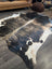 A beautiful extra large black and white cowhide rug with a textured irregular pattern laid on a wooden floor
