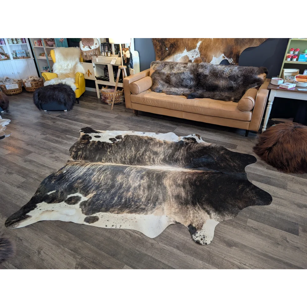 Extra large black and white natural cowhide rug with distinctive spotted pattern perfect for beautiful rugs and large cowhide decor