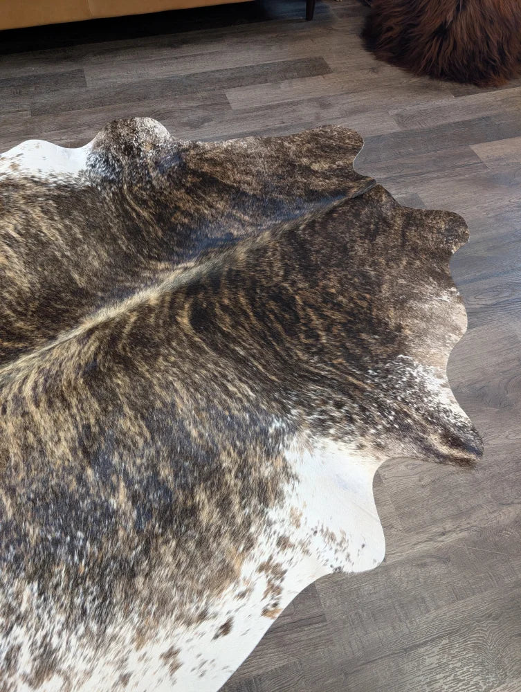 Brown and white extra large cowhide rug with natural irregular edges perfect for beautiful rugs and large cowhide decor