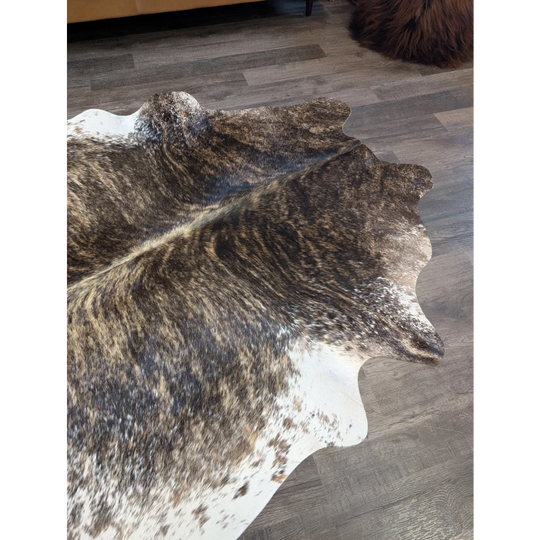Brown and white extra large cowhide rug with natural irregular edges perfect for beautiful rugs and large cowhide decor