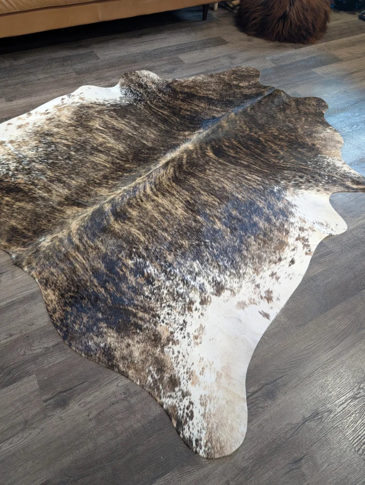 Brown and white extra large cowhide rug with natural irregular patterns perfect for beautiful rugs and large cowhide decor