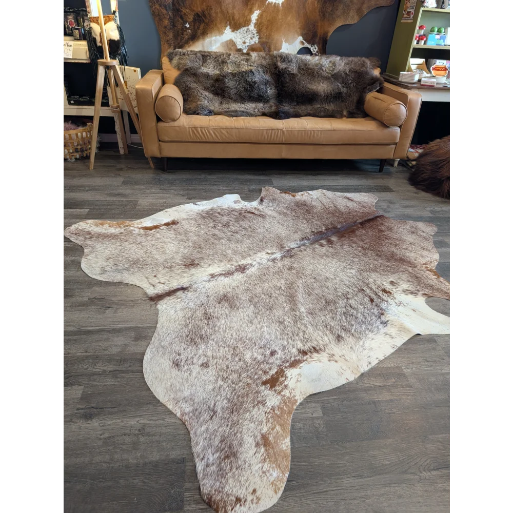 Gorgeous extra large cowhide rug in brown and white with natural fur texture perfect for beautiful rugs lovers