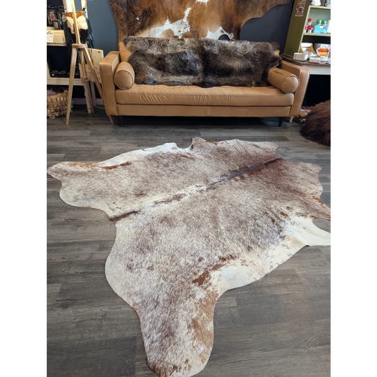 Gorgeous extra large cowhide rug in brown and white with natural fur texture perfect for beautiful rugs lovers