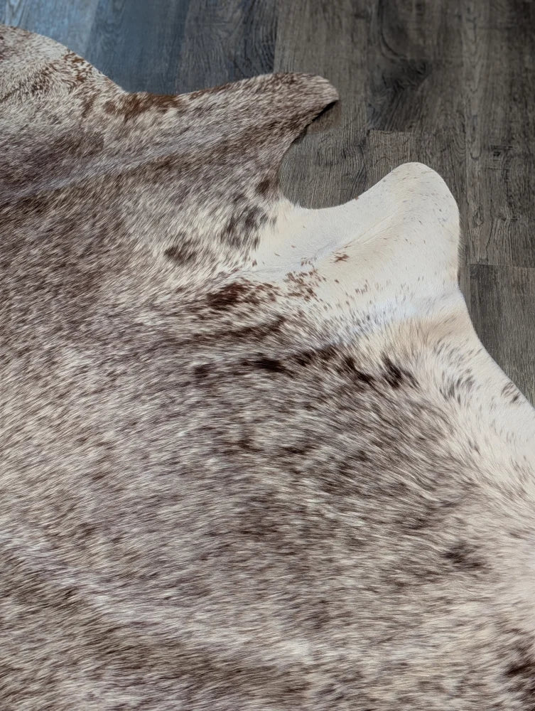 Extra large natural brown and white cowhide rug with textured fur surface perfect for beautiful rugs or large cowhide decor