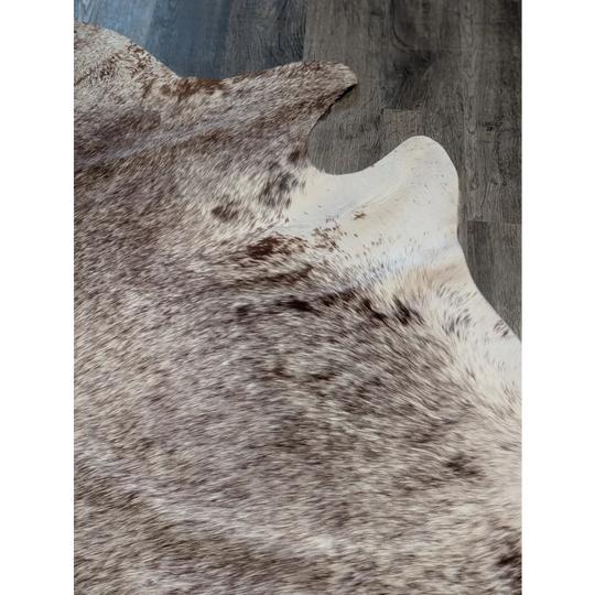 Extra large natural brown and white cowhide rug with textured fur surface perfect for beautiful rugs or large cowhide decor