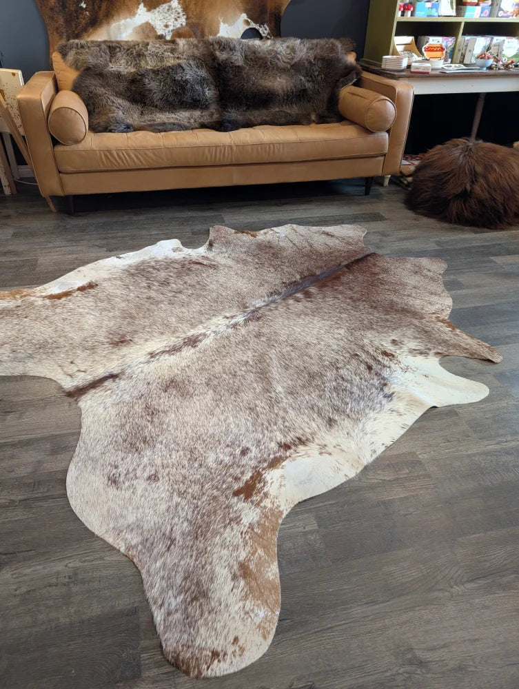 Extra large natural brown and white cowhide rug with textured fur surface perfect for beautiful rugs and large cowhide lovers