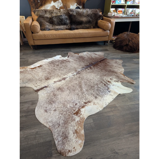 Extra large natural brown and white cowhide rug with textured fur surface perfect for beautiful rugs and large cowhide lovers