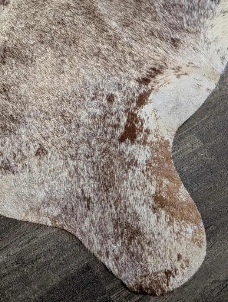 Extra large cowhide rug with white and brown mottled fur perfect for beautiful rugs and large cowhide decor