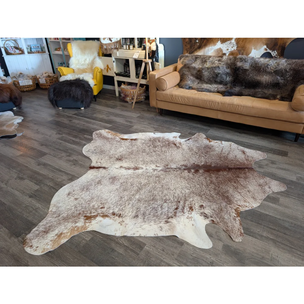 Extra large natural cowhide rug with beautiful mottled white brown and tan patches perfect for large cowhide decor