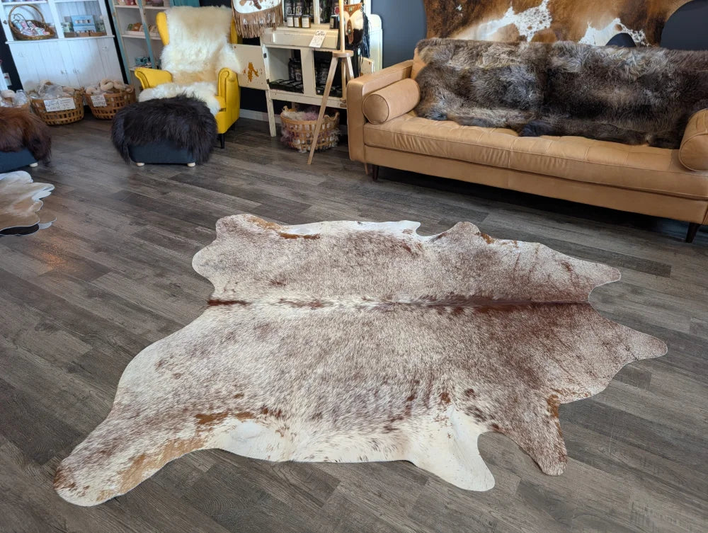 Extra large natural cowhide rug with beautiful mottled white brown and tan patches perfect for large cowhide decor