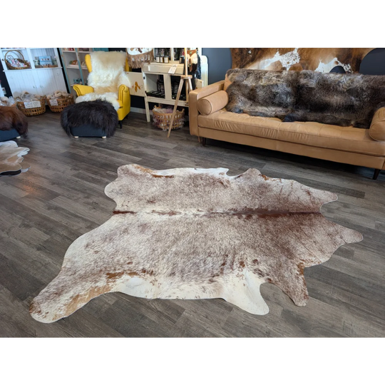 Extra large natural cowhide rug with beautiful mottled white brown and tan patches perfect for large cowhide decor