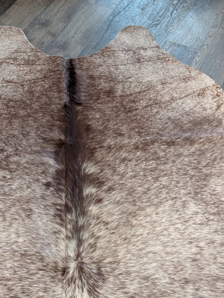 Extra large beautiful rugs featuring a brown and beige cowhide with natural fur texture perfect as a large cowhide decor