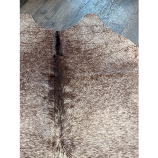 Extra large beautiful rugs featuring a brown and beige cowhide with natural fur texture perfect as a large cowhide decor