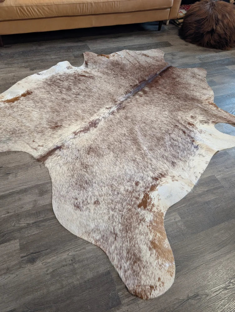 Extra large natural brown and white cowhide rug with textured fur surface perfect for beautiful rugs collection