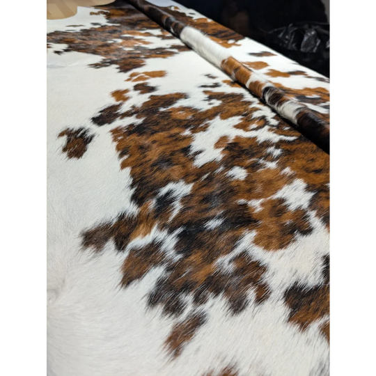 Extra large cowhide rug with brown and white patches, soft underfoot texture