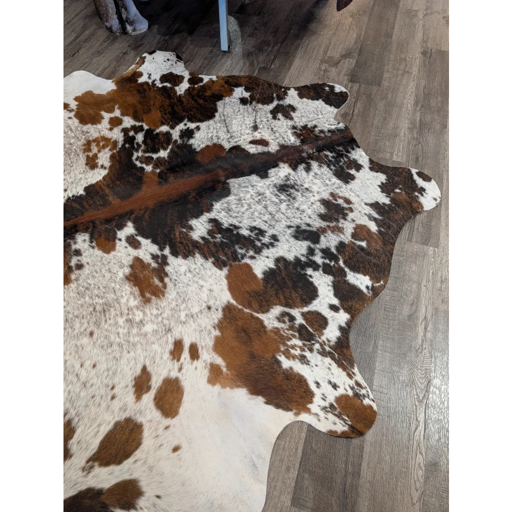 Extra large cowhide rug tricolour101 with brown and white natural edges showing rustic charm and unique characteristics